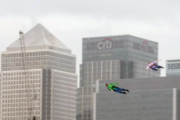 A human figure flying between the towers of Canary Wharf, in giffgaff’s drone stunt