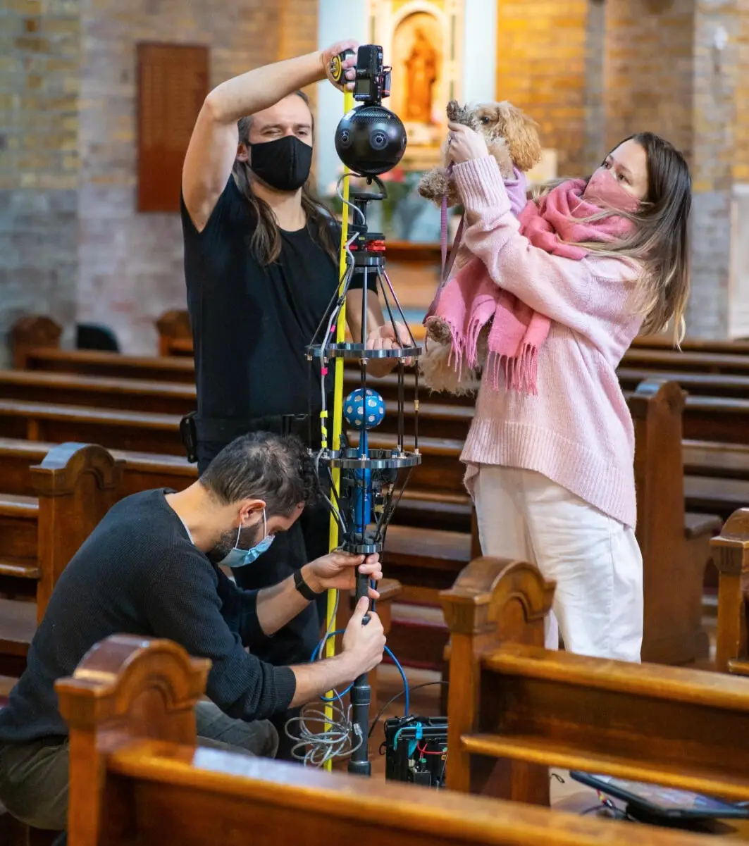 A spatial audio and 360 camera rig set up in a church, with the recording team